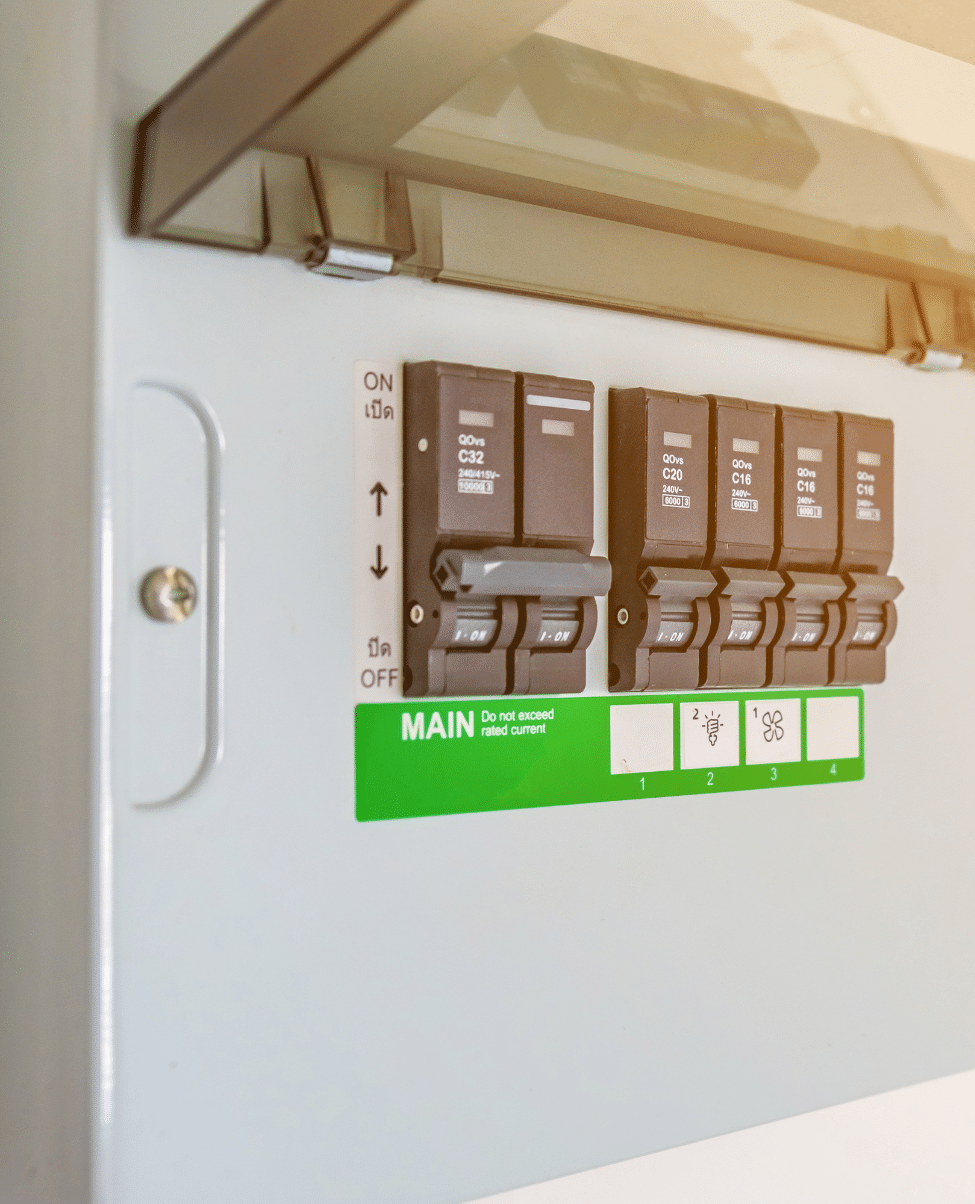 Untitled design (17) A close-up view of an electrical breaker panel with multiple black switches, each meticulously labeled. A green label that says "MAIN" is positioned below the switches. The instructions "ON" and "OFF" are printed on the left part of the panel. This setup is typical for homes on the Sunshine Coast.