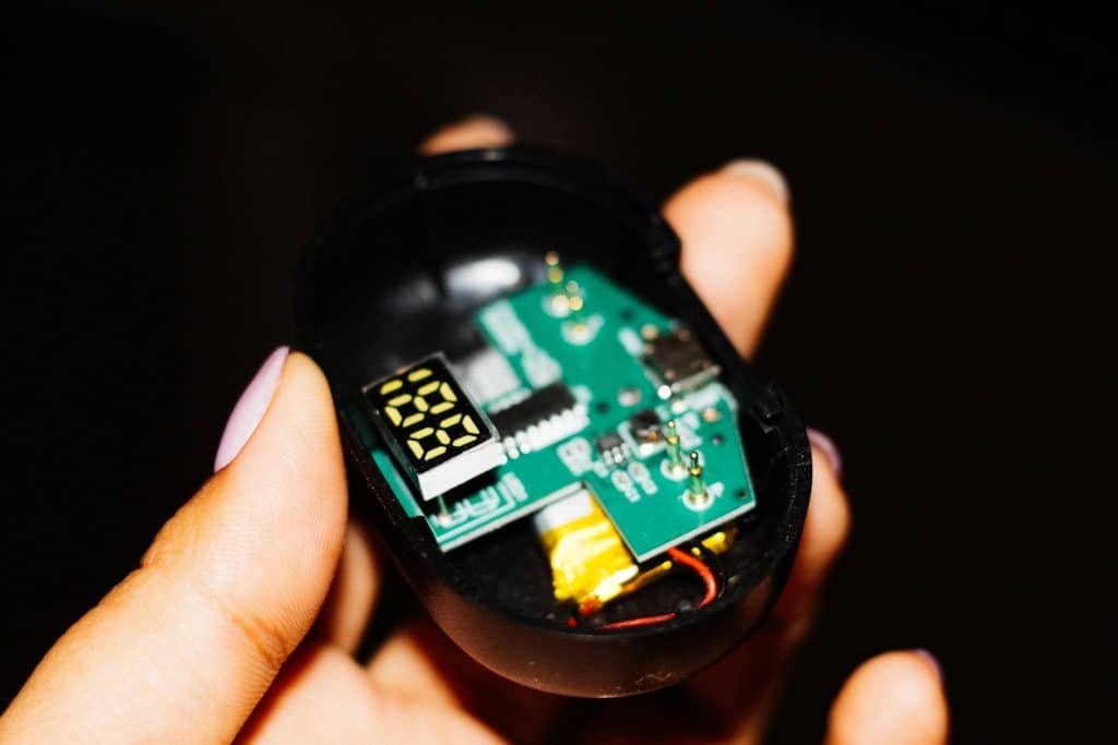 a close up of a person holding a small electronic device